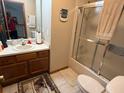 Full bathroom features a shower-tub combo, single vanity, and large mirror at 1473 Disston Ave, Clermont, FL 34711