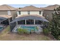 Aerial view of a screened-in pool and patio area nestled in a well-manicured backyard at 1494 Moon Valley Dr, Davenport, FL 33896