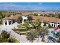 Aerial view of the clubhouse with a water feature, playground, and waterslide at 1494 Moon Valley Dr, Davenport, FL 33896