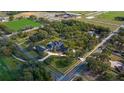 Aerial view of large estate with swimming pool, perfectly manicured lawns, mature trees, and a horse training facility at 1501 Lake Markham Rd, Sanford, FL 32771