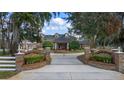 Beautiful estate home featuring brick entrance with landscaped garden, water feature, and manicured grounds under a blue sky at 1501 Lake Markham Rd, Sanford, FL 32771