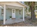 Inviting front porch with a welcoming wreath and a charming entryway, enhancing the home's curb appeal at 1744 E Welch Rd, Apopka, FL 32712