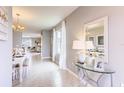 Bright home foyer with modern decor, light gray walls, tile flooring, and lots of natural light at 1847 Waggoner St, Kissimmee, FL 34744