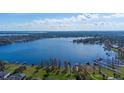 Overhead view showcasing tranquil lake access with private docks and lush surroundings at 1910 Lake Roberts Landing Dr, Winter Garden, FL 34787