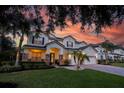 Charming two-story home showcasing a manicured lawn, and a welcoming entrance beneath a dramatic sky at 1910 Lake Roberts Landing Dr, Winter Garden, FL 34787