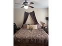 Comfortable bedroom with a ceiling fan, neutral walls, and inviting bedding at 1997 Dixie Belle Dr # 1997C, Orlando, FL 32812