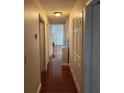 Hallway with wood flooring, neutral walls, and practical storage space at 1997 Dixie Belle Dr # 1997C, Orlando, FL 32812