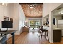 Open-concept living room with wood ceiling, hardwood floors, and bright natural light at 200 Maitland Ave # 96, Altamonte Springs, FL 32701
