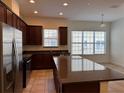 Open kitchen features dark wood cabinets, granite countertops and stainless steel appliances at 2205 W Lobelia Dr, Lake Mary, FL 32746