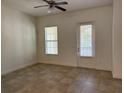 Bright living room features neutral walls, tiled floors, and a sliding door to outside at 2205 W Lobelia Dr, Lake Mary, FL 32746