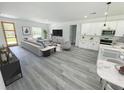 Inviting living room with wood floors, a modern sofa, and an open floorplan at 2409 Sw 170Th Pl, Ocala, FL 34473
