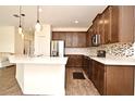 Modern kitchen features stainless steel appliances, stylish cabinets, and granite countertops at 2659 Magpie Way, Sanford, FL 32773