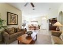 Bright living room with comfortable seating, decorative art, and an arched doorway to the dining area at 305 Grand Reserve Dr, Davenport, FL 33837