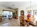 Open-concept living space with dining area, comfortable seating, and sliding glass doors to the outside at 305 Grand Reserve Dr, Davenport, FL 33837