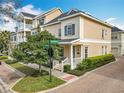 Charming two-story townhome with a welcoming front porch and manicured landscaping on a sunny day at 411 Old Farm Ln, Winter Springs, FL 32708