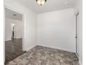Cozy dining room features stylish gray tiled flooring, freshly painted white walls and an entry door to the backyard at 416 Davis Dr, Orlando, FL 32803