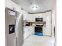 Modern kitchen with white cabinets, stainless steel appliances, and tiled flooring for a clean and bright space at 425 Walnut St, Daytona Beach, FL 32114