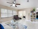 Comfortable living room with ceiling fan, open to the dining area, and featuring neutral paint and tile flooring at 425 Walnut St, Daytona Beach, FL 32114
