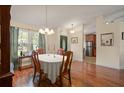 Cozy dining room with hardwood floors, classic furniture, and view of front door at 5019 Log Wagon Rd, Ocoee, FL 34761