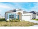 Inviting single-story home showcasing a well-kept lawn, neutral paint, and a two-car garage at 5342 Maddie Dr, Haines City, FL 33844