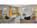 Comfortable living room with a fireplace, large TV, and sliding glass door at 574 Lady Grace Pl, Deland, FL 32724
