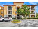 Stunning three-story condo showcasing balconies, lush landscaping, and convenient parking that offers a comfortable living experience at 6157 Metrowest Blvd # 106, Orlando, FL 32835