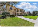 Beautiful two-story home with lush green lawn, brick driveway, and a welcoming facade at 8424 Lake Burden Cir, Windermere, FL 34786