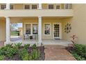 Charming front porch with brick walkway, decorative pillars, and seating at 8424 Lake Burden Cir, Windermere, FL 34786