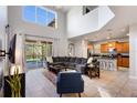 Open-concept living space boasts soaring ceilings, a modern kitchen, and seamless access to an outdoor patio at 8961 Cuban Palm Rd, Kissimmee, FL 34747