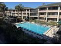 Exterior view of a well-maintained community pool surrounded by lush landscaping at 125 Water Front Way # 200, Altamonte Springs, FL 32701