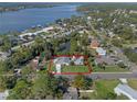 Aerial view showcasing the property's layout and proximity to the lake at 1300 Conrad Dr, New Smyrna Beach, FL 32168