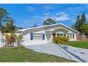 Beautiful home with a well-manicured lawn and a spacious driveway at 1300 Conrad Dr, New Smyrna Beach, FL 32168