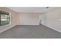 Neutral bedroom with a large window, tile flooring and view to the attached bathroom at 1515 Angler Ave, Kissimmee, FL 34746