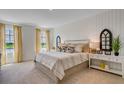 Bright bedroom featuring a shiplap accent wall, two windows and neutral furnishings and decor at 1706 Three Bars Rd, Kissimmee, FL 34744
