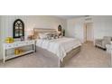 Bright bedroom showcasing a queen size bed with a shiplap wall and neutral accents at 1706 Three Bars Rd, Kissimmee, FL 34744