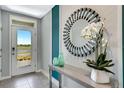 Light and bright entryway featuring a decorative mirror, a console table with vases, and a view of the lake at 1718 Three Bars Rd, Kissimmee, FL 34744