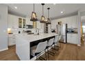 Modern kitchen with stainless steel appliances, white cabinets, and a large center island at 1832 Farnham Dr, Ocoee, FL 34761