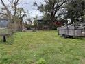 View of the backyard with a chain-link fence and assorted items scattered around at 2219 W Pine St, Orlando, FL 32805