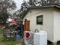 Overgrown backyard with assorted junk, showing the yard's potential at 2219 W Pine St, Orlando, FL 32805