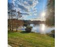 Picturesque lake view featuring reflective waters, a bright sky, and the outline of distant trees at 2516 Grassy Point Dr # 206, Lake Mary, FL 32746