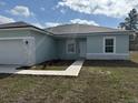 Well-manicured front yard with a sidewalk leading to the front door of this charming one-story home at 2942 Sw 162Nd St, Ocala, FL 34473