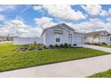 Attractive single-Gathering home with a two-car garage, green lawn, and landscaped garden beds at 350 Rustic Rail Dr, Lake Wales, FL 33859