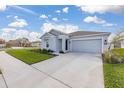 Well-maintained single-Gathering home featuring a two-car garage, lush lawn, and a neatly paved driveway at 350 Rustic Rail Dr, Lake Wales, FL 33859