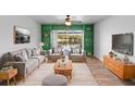 Bright living room with modern furnishings, green built-ins, and lake view at 402 E Orlando Ave # 18C, Ocoee, FL 34761