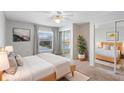 Bright bedroom with light wood floors, a comfy bed, and ample closet space at 402 E Orlando Ave # 18C, Ocoee, FL 34761