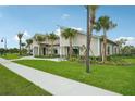 Charming clubhouse exterior featuring stone accents, lush green landscaping, and sidewalk access at 4110 Gooseberry Trl, Kissimmee, FL 34746