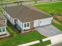 Beautiful home with a two car garage, a perfectly manicured lawn, and stone accents at 4110 Gooseberry Trl, Kissimmee, FL 34746