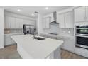 Modern kitchen featuring stainless steel appliances, a spacious island, and stylish backsplash at 4110 Gooseberry Trl, Kissimmee, FL 34746