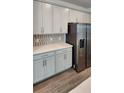 Beautiful kitchen featuring stainless steel refrigerator and stylish backsplash at 4110 Gooseberry Trl, Kissimmee, FL 34746