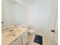Half bathroom with white fixtures, tile flooring, a large mirror and neutral paint at 4304 Clubside Dr # 4304, Longwood, FL 32779